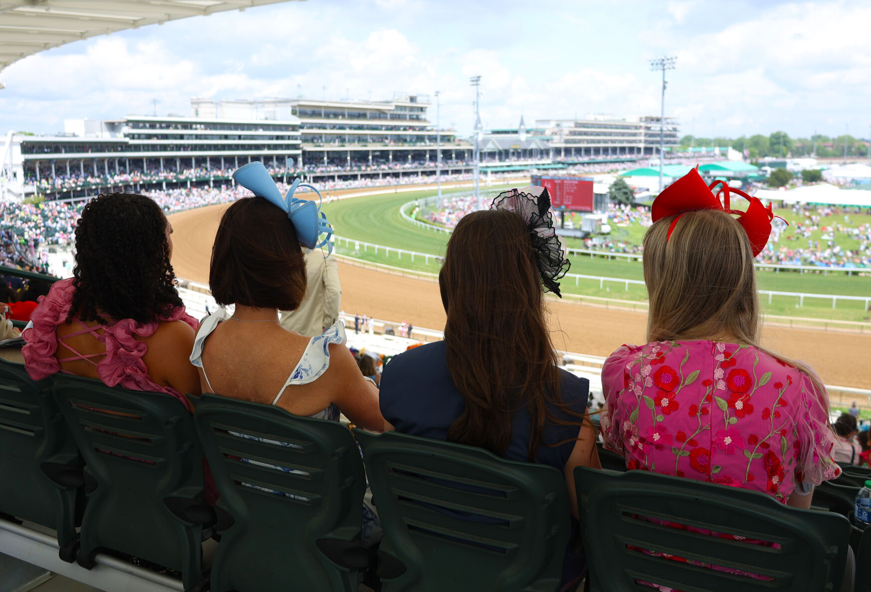 Four women watch from First Turn Club.JPG
